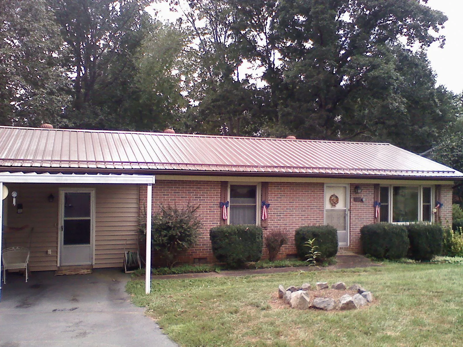 Bronze metal roof and carport on a brick ranch home — Roof Repair work by our crew in West Sacramento