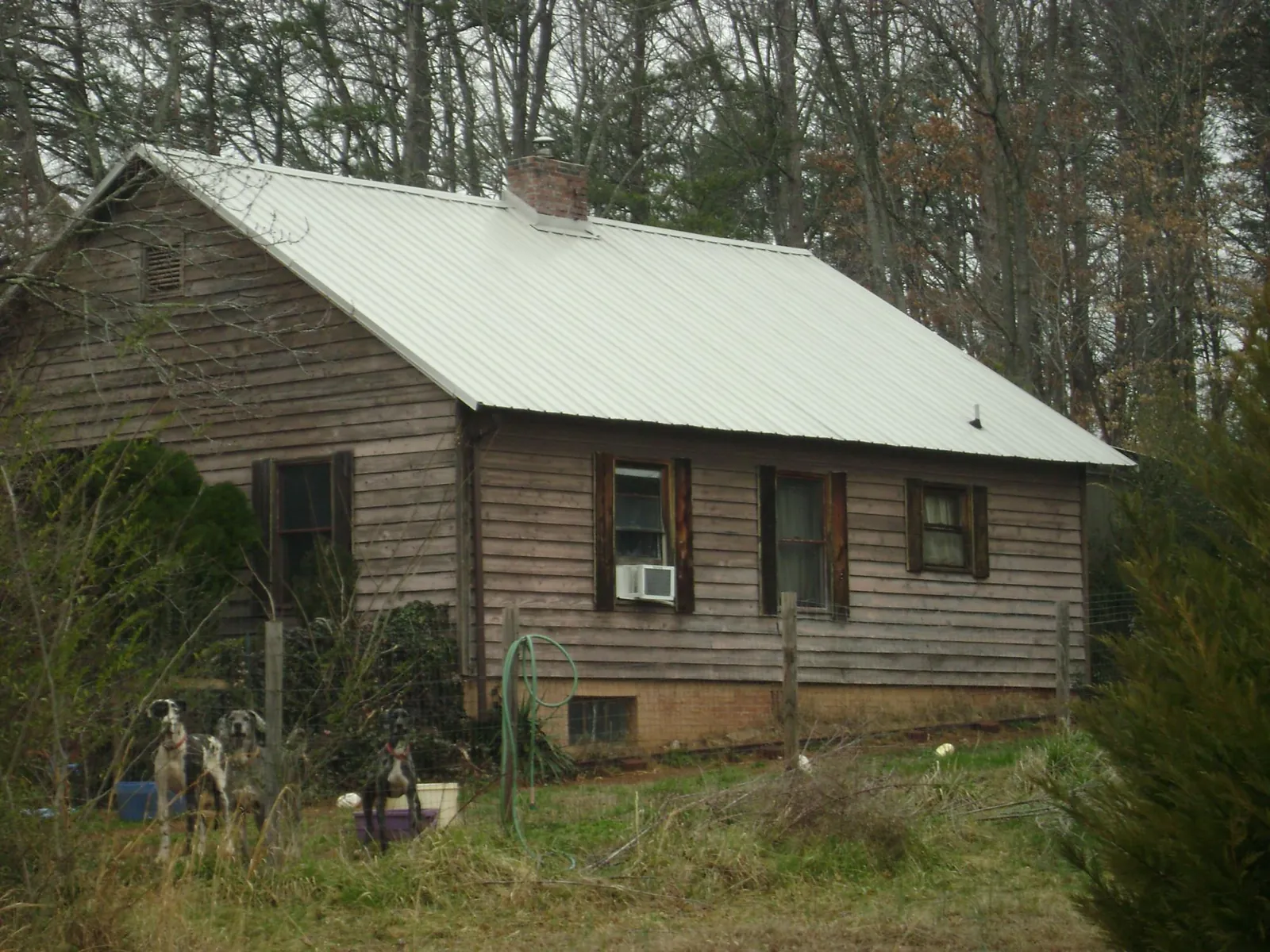 White metal roof on an old wood sided farmhouse, from a Metal Roof Installation job in West Sacramento